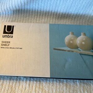 Umbra from the Container Store glass wall shelf